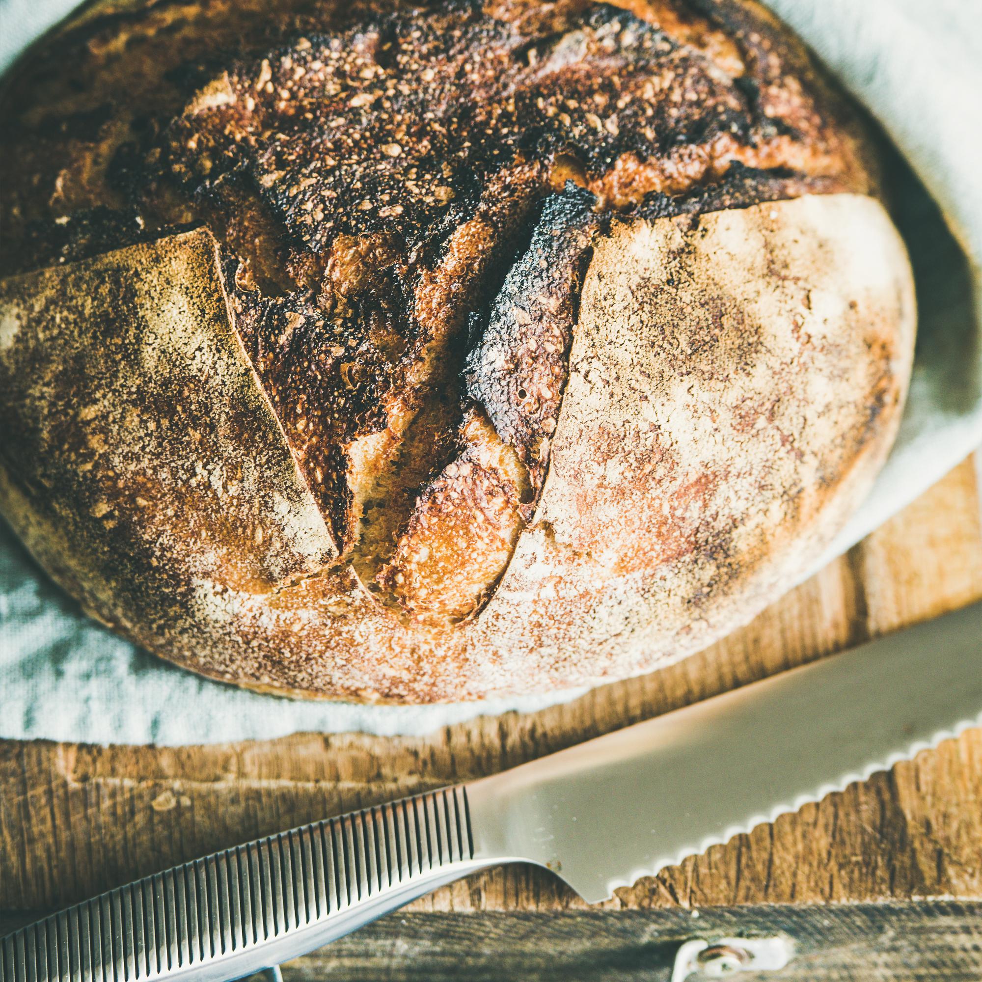 Artisan sourdough loaf cooling on rack